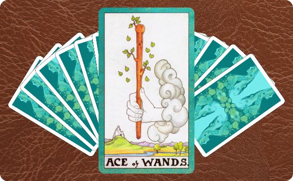 Rider Waite depiction of the Ace of Wands tarot card sitting on top of a spread of other cards.