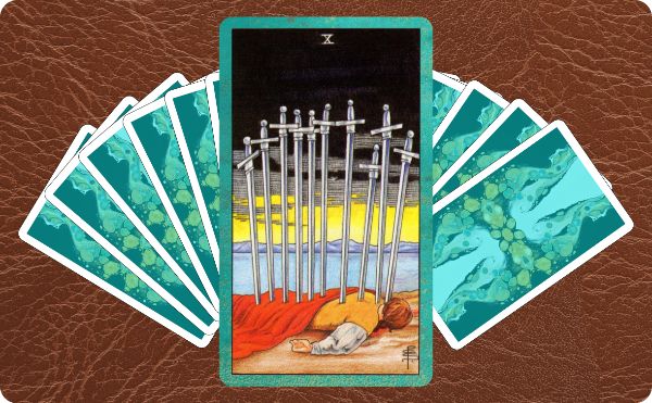Rider Waite depiction of the Ten of Swords tarot card on top of a spread of other cards.