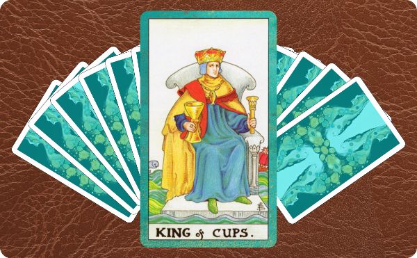 Rider Waite depiction of the King of Cups tarot card on top of a spread of other cards