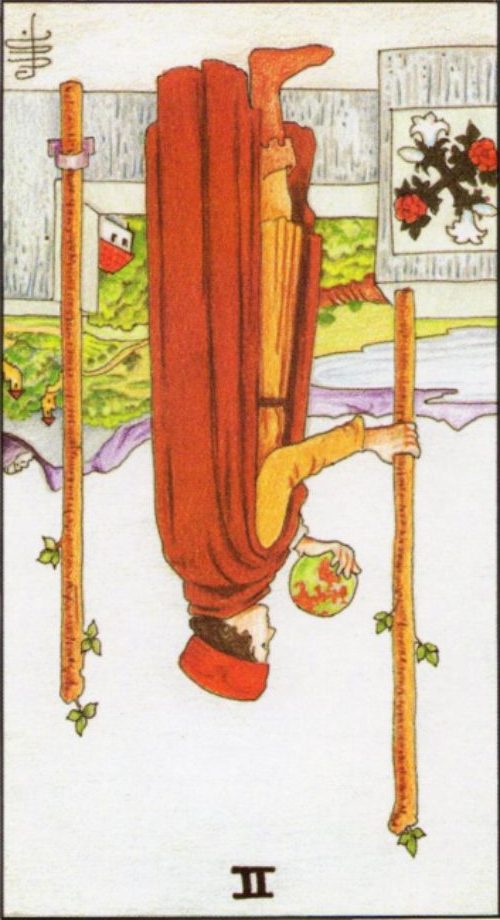 Rider Waite depiction of the Two of Wands tarot card reversed. 