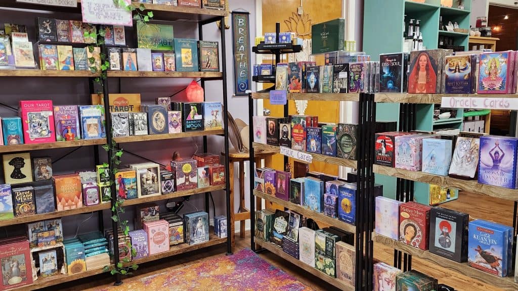 Shelves of Tarot card decks in a metaphysical supply store.