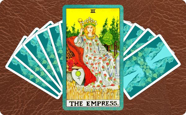 Rider Waite depiction of The Empress tarot card on top of a spread of several cards.
