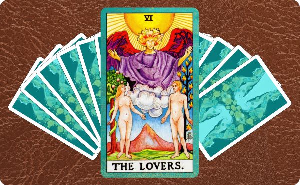 Rider Waite depiction of The Lovers tarot card on top of a spread of several cards
