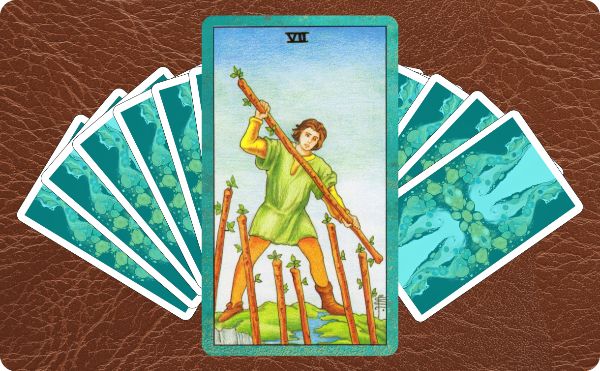 Rider Waite depiction of the Seven of Wands tarot card sitting on top of a spread of other cards.